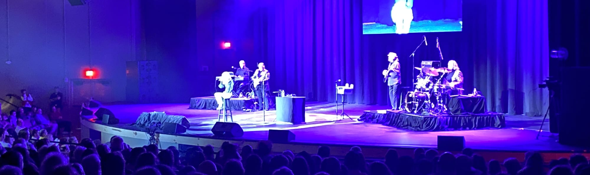 signer on stage in chair washed out by the lights Reno